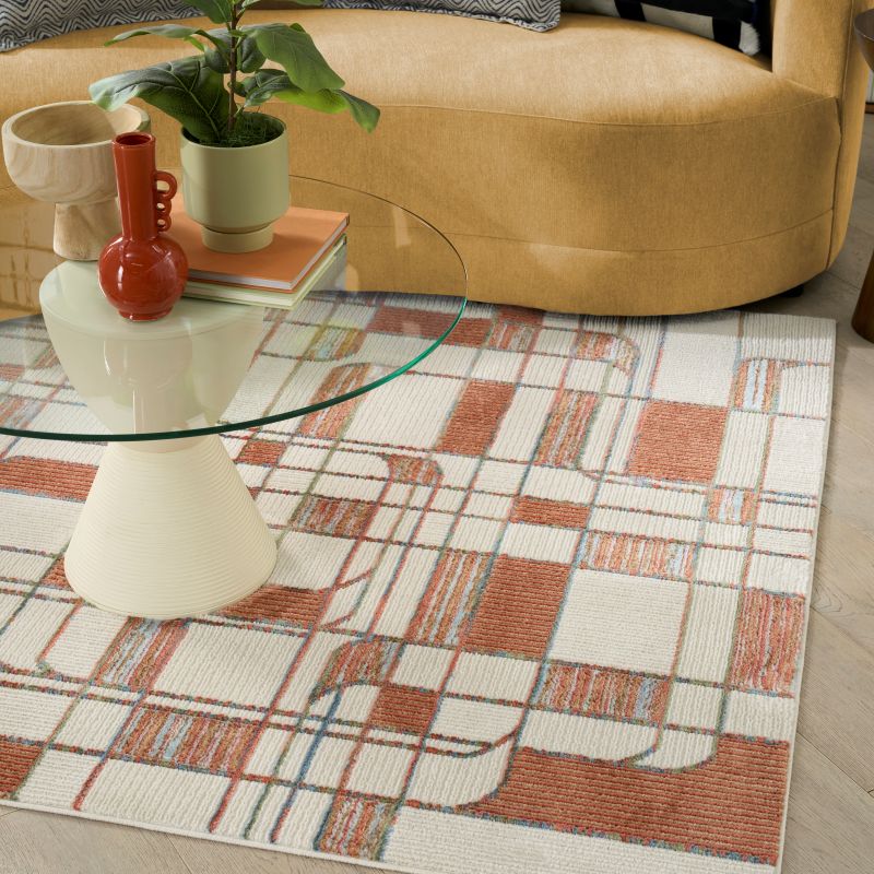Angled view of a retro rug under a coffee table and sofa