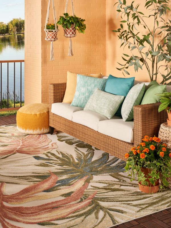 Colorful patio featuring a tropical rug, flowers, and plants
