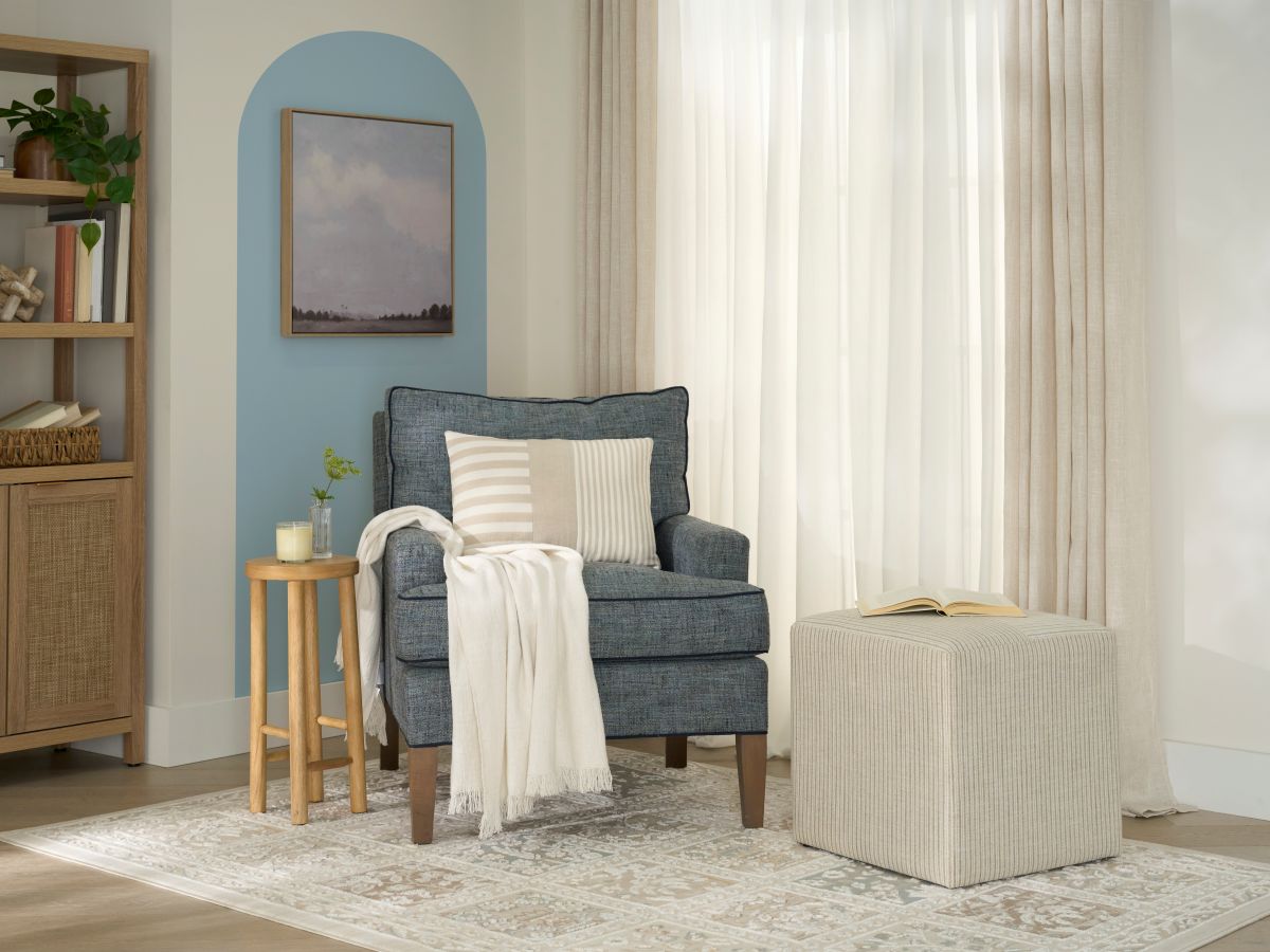 Cozy nook with an armchair, painted arch wall, and textured rug