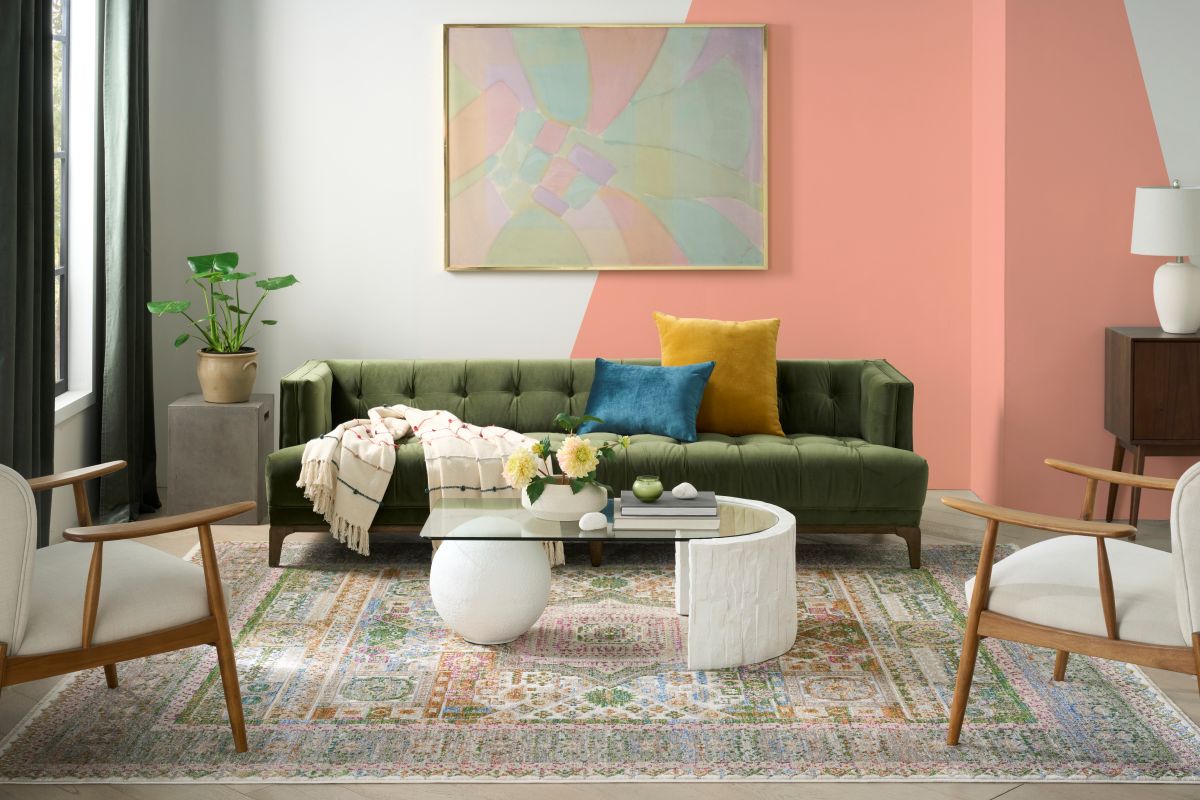 Living room with a painted triangle wall and colorful vintage-style rug