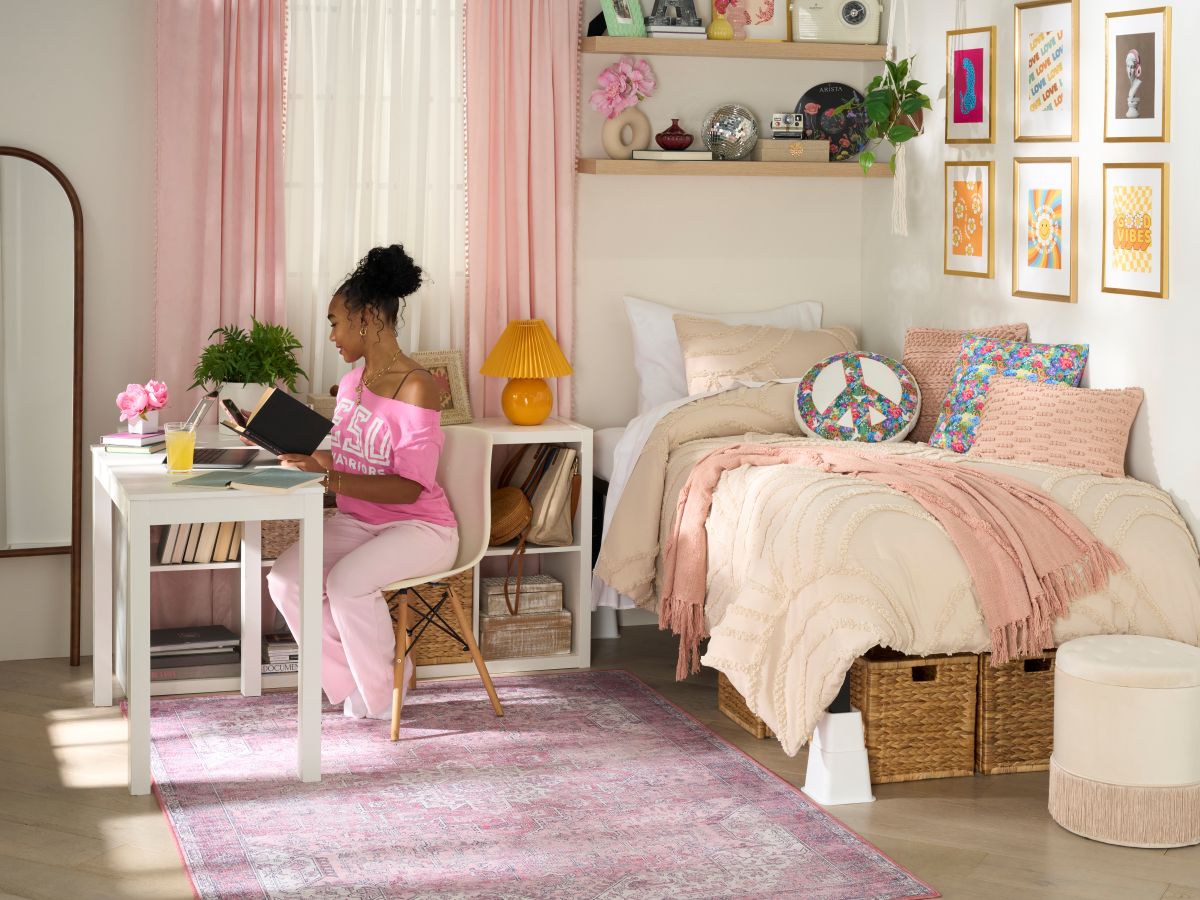 Girl seated at a desk in a dorm room
