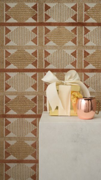 Cocktail on a plinth in front of a Scandinavian style geometric rug