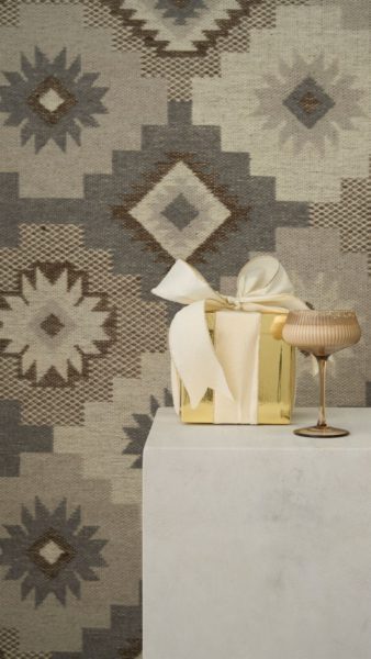 Martini glass on a plinth in front of a Scandinavian-style neutral rug