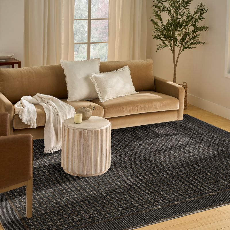 Modern living room with a black geometric rug on the ground
