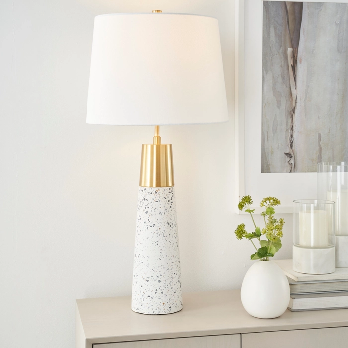 29-inch BIT02 white and gold ceramic buffet lamp with tapered drum shade on a light console beside a white vase with greenery and a candle