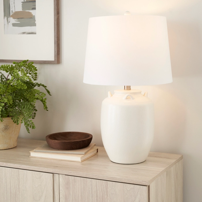 24-inch BIT10 white ceramic table lamp with drum shade on a light wood console beside a potted fern and wooden bowl