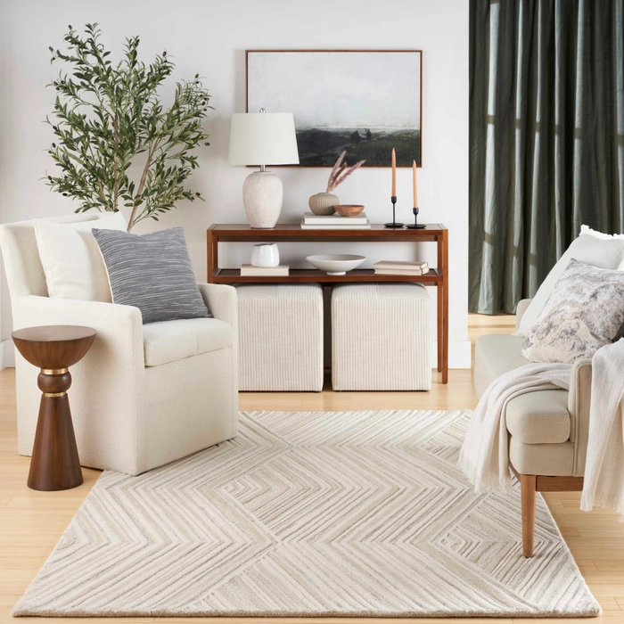 Graceful GRU03 ivory area rug in a neutral living room with white armchairs, wooden console table, and olive tree