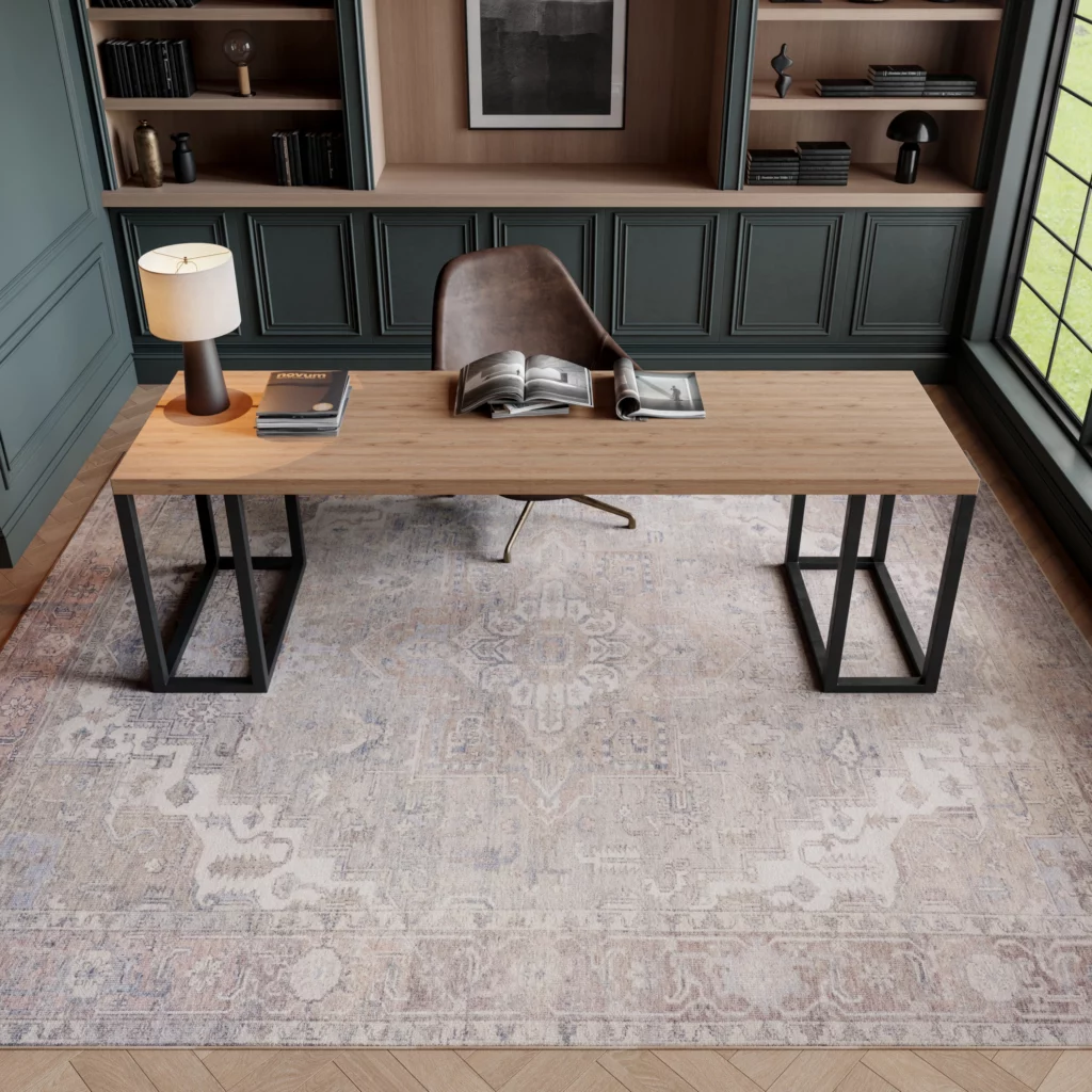 Nourison Vivid Washables VWS07 Light Blue 8x10 distressed medallion area rug under a wood and black metal desk in a moody dark green home office with built-in shelving